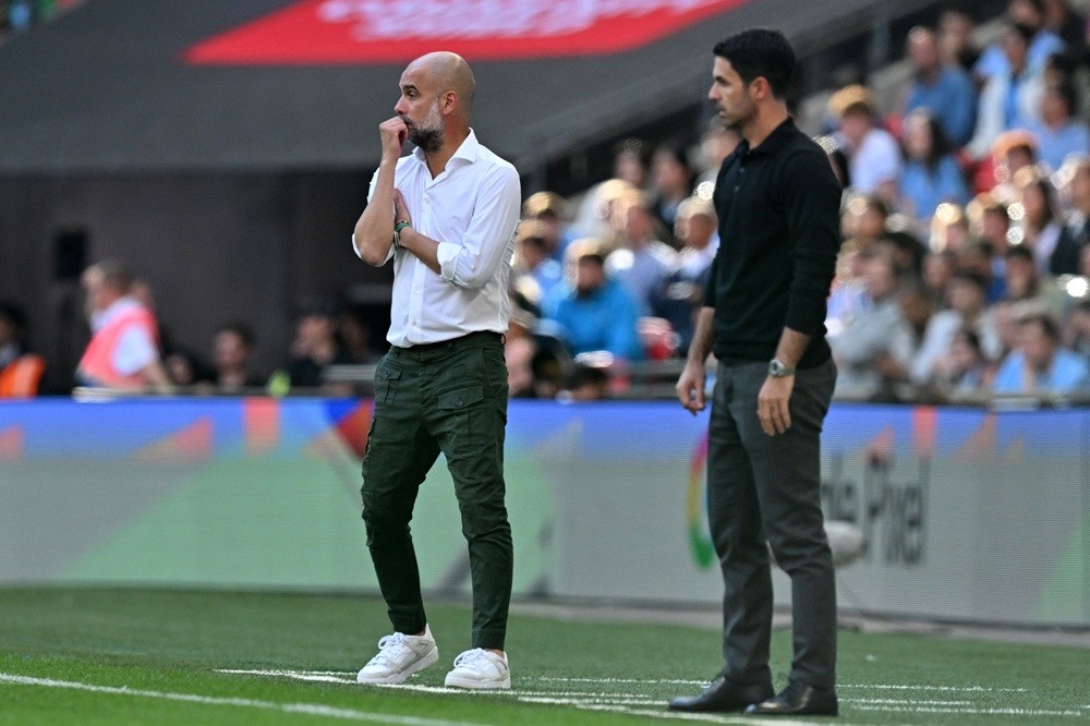 Manchester City's Spanish manager Pep Guardiola (L) and Arsenal's Spanish manager Mikel Arteta (R) look on during the English FA Community Shield football match between Arsenal and Manchester City at Wembley Stadium, in London, August 6, 2023. (Photo by GLYN KIRK/AFP via Getty Images)