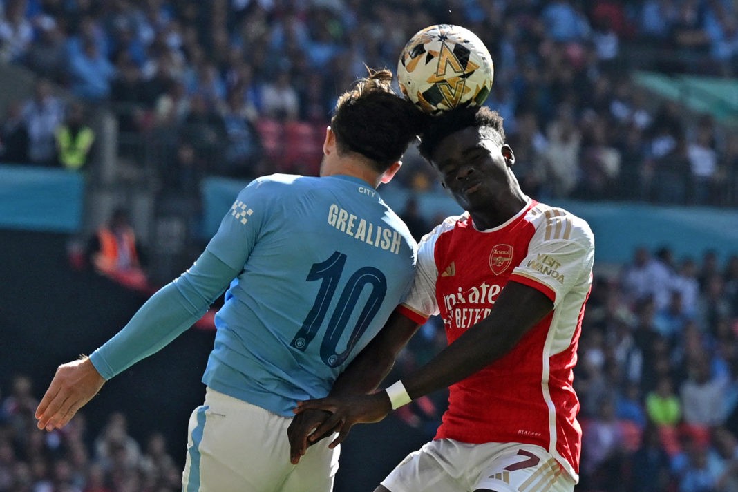 Manchester City's English midfielder Jack Grealish (L) vies with Arsenal's English midfielder Bukayo Saka (R) during the English FA Community Shield football match between Arsenal and Manchester City at Wembley Stadium, in London, August 6, 2023. (Photo by Glyn KIRK / AFP) / NOT FOR MARKETING OR ADVERTISING USE / RESTRICTED TO EDITORIAL USE (Photo by GLYN KIRK/AFP via Getty Images)