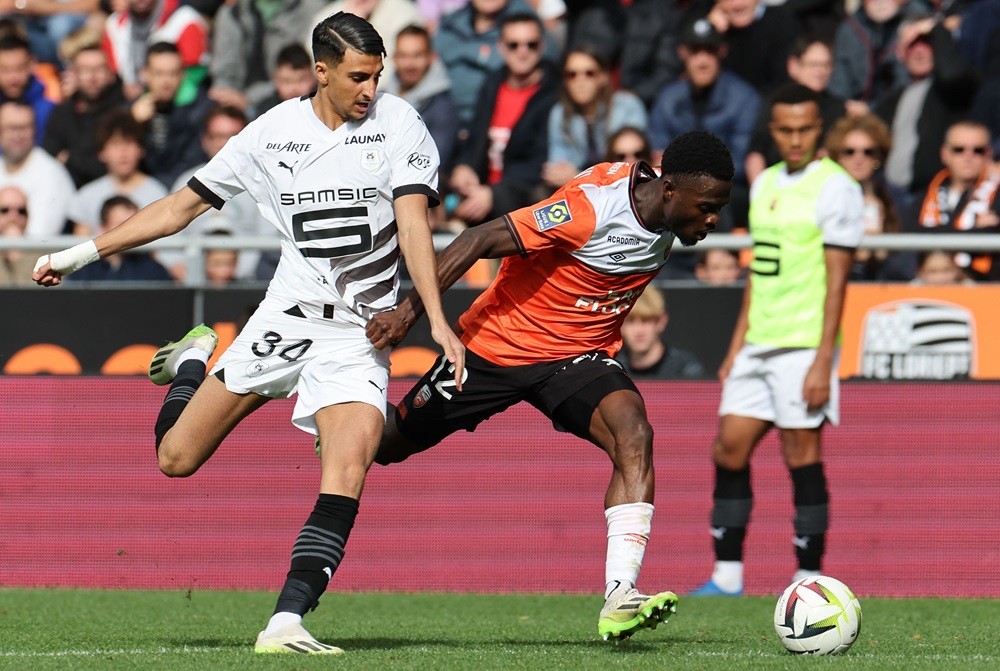 Lorient's Darlin Yongwa (L) fights for the ball with Ibrahim Salah during the French L1 football match between FC Lorient and Stade Rennais FC at the Moustoir stadium in Lorient, western France, on October 22, 2023. (Photo by FRED TANNEAU/AFP via Getty Images)