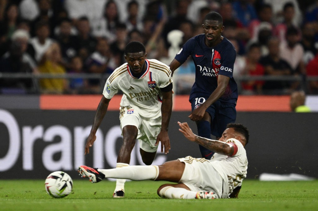 Lyon's English midfielder #98 Ainsley Maitland-Niles (L) and Lyon's French midfielder #08 Corentin Tolisso (bottom) fight for the ball with Paris Saint-Germain's French forward #10 Ousmane Dembele (C) during the French L1 football match between Olympique Lyonnais (OL) and Paris Saint-Germain (PSG) at The Groupama Stadium in Decines-Charpieu, central-eastern France on September 3, 2023. (Photo by JEFF PACHOUD/AFP via Getty Images)
