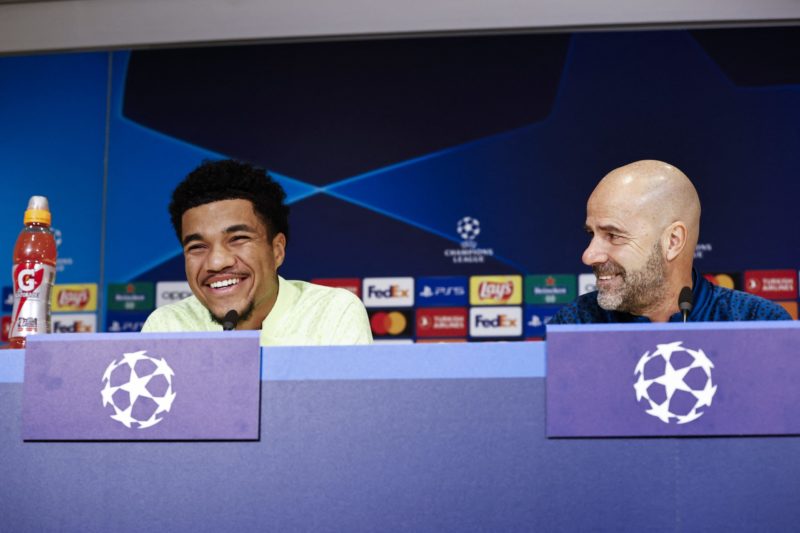 PSV Eindhoven's US midfielder Malik Tillman (L) and PSV Eindhoven's coach Peter Bosz give a press conference prior to the UEFA Champions League group B football match against Arsenal FC at the Phillips stadium in Eindhoven on December 11, 2023. (Photo by MAURICE VAN STEEN/ANP/AFP via Getty Images)