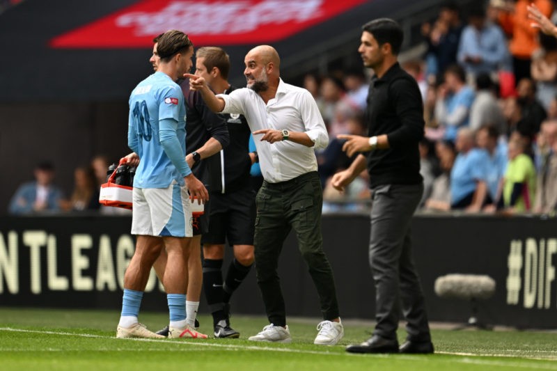 LONDON, ENGLAND - AUGUST 06: Pep Guardiola, Manager of Manchester City gives instructions to Jack Grealish of Manchester City during The FA Community Shield match between Manchester City against Arsenal at Wembley Stadium on August 06, 2023 in London, England. (Photo by Shaun Botterill/Getty Images)