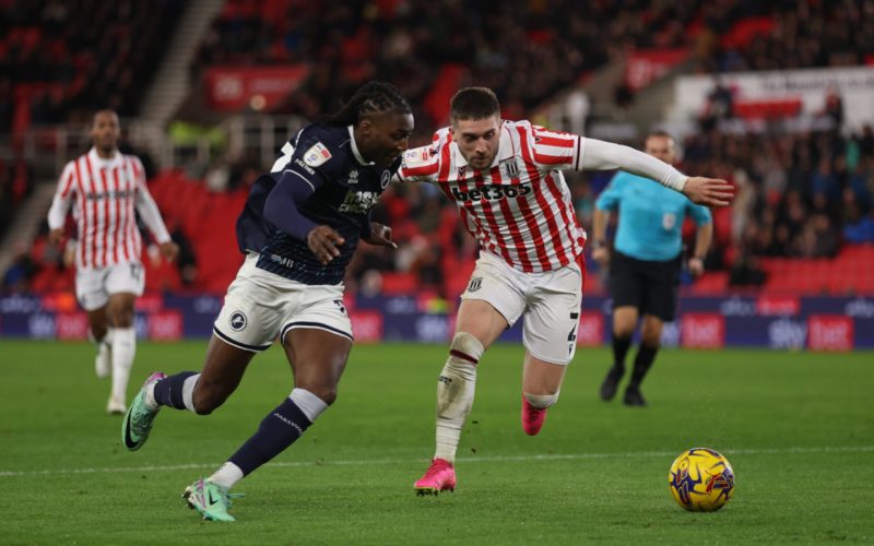 STOKE ON TRENT, ENGLAND - DECEMBER 23: Brooke Norton-Cuffy of Millwall runs past Lynden Gooch of Stoke City during the Sky Bet Championship match between Stoke City and Millwall at Bet365 Stadium on December 23, 2023 in Stoke on Trent, England. (Photo by Nathan Stirk/Getty Images)