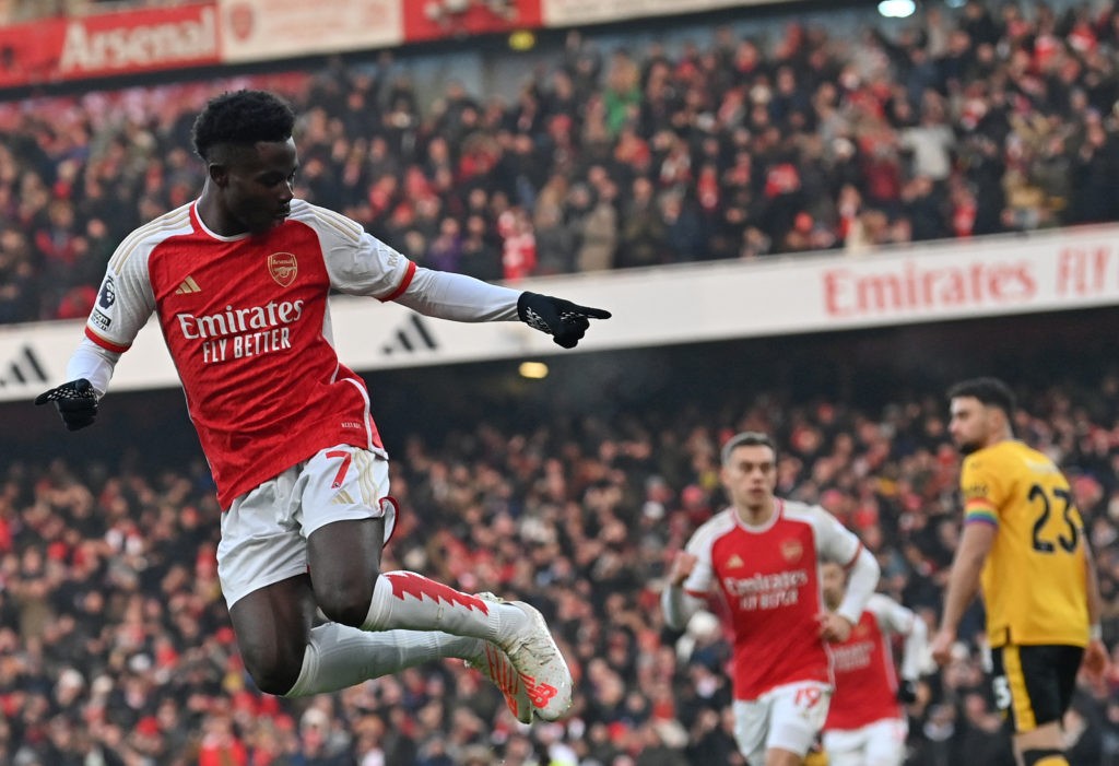 TOPSHOT - Arsenal's English midfielder #07 Bukayo Saka celebrates scoring the opening goal during the English Premier League football match between Arsenal and Wolverhampton Wanderers at the Emirates Stadium in London on December 2, 2023. (Photo by GLYN KIRK/AFP via Getty Images)