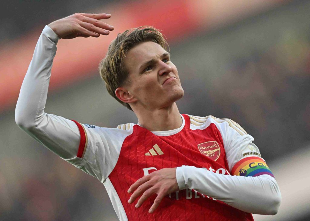 TOPSHOT - Arsenal's Norwegian midfielder #08 Martin Odegaard celebrates scoring the team's second goal during the English Premier League football match between Arsenal and Wolverhampton Wanderers at the Emirates Stadium in London on December 2, 2023. (Photo by GLYN KIRK/AFP via Getty Images)