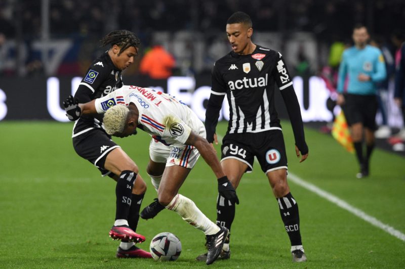 Lyon's Brazilian midfielder Thiago Mendes (C) fights for the ball with Angers' French midfielder Jean-Matteo Bahoya (L) next to Angers' French defender Yan Valery (R) during the French L1 football match between SCO Angers and Olympique Lyonnais (OL) at The Raymond-Kopa Stadium in Angers, western France on February 25, 2023.  (Photo by JEAN-FRANCOIS MONIER/AFP via Getty Images)