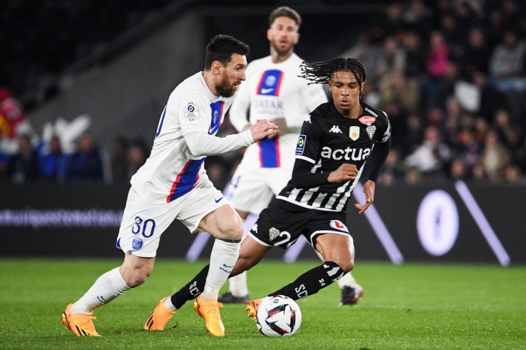 Paris Saint-Germain's Argentine forward Lionel Messi fights for the ball with Angers' French midfielder Jean-Matteo Bahoya during the French L1 football match between SCO Angers and Paris Saint-Germain (PSG) at The Raymond-Kopa Stadium in Angers, western France on April 21, 2023. (Photo by JEAN-FRANCOIS MONIER / AFP) (Photo by JEAN-FRANCOIS MONIER/AFP via Getty Images)