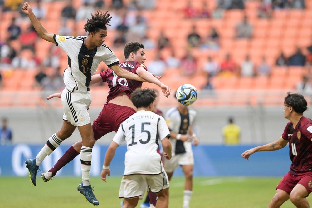 Germany's David Odogu (L) and Venezuela's Alenjandro Cichero (2nd L) fight for the ball during the FIFA U-17 World Cup Indonesia 2023 Group F football match between Germany and Venezuela at the Jakarta International Stadium in Jakarta on November 18, 2023. (Photo by BAY ISMOYO/AFP via Getty Images)