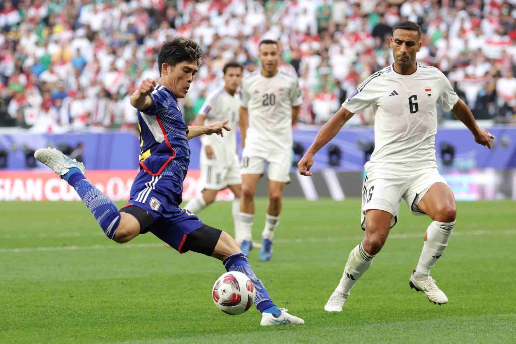 AL RAYYAN, QATAR - JANUARY 19: Takehiro Tomiyasu of Japan shoots whilst under pressure from Ali Adnan of Iraq during the AFC Asian Cup Group D match between Iraq and Japan at Education City Stadium on January 19, 2024 in Al Rayyan, Qatar. (Photo by Lintao Zhang/Getty Images)