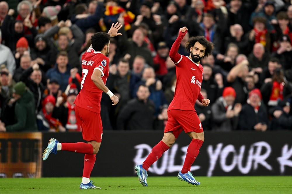 LIVERPOOL, ENGLAND: Mohamed Salah of Liverpool celebrates after scoring their team's first goal during the Premier League match between Liverpool FC and Arsenal FC at Anfield on December 23, 2023. (Photo by Michael Regan/Getty Images)