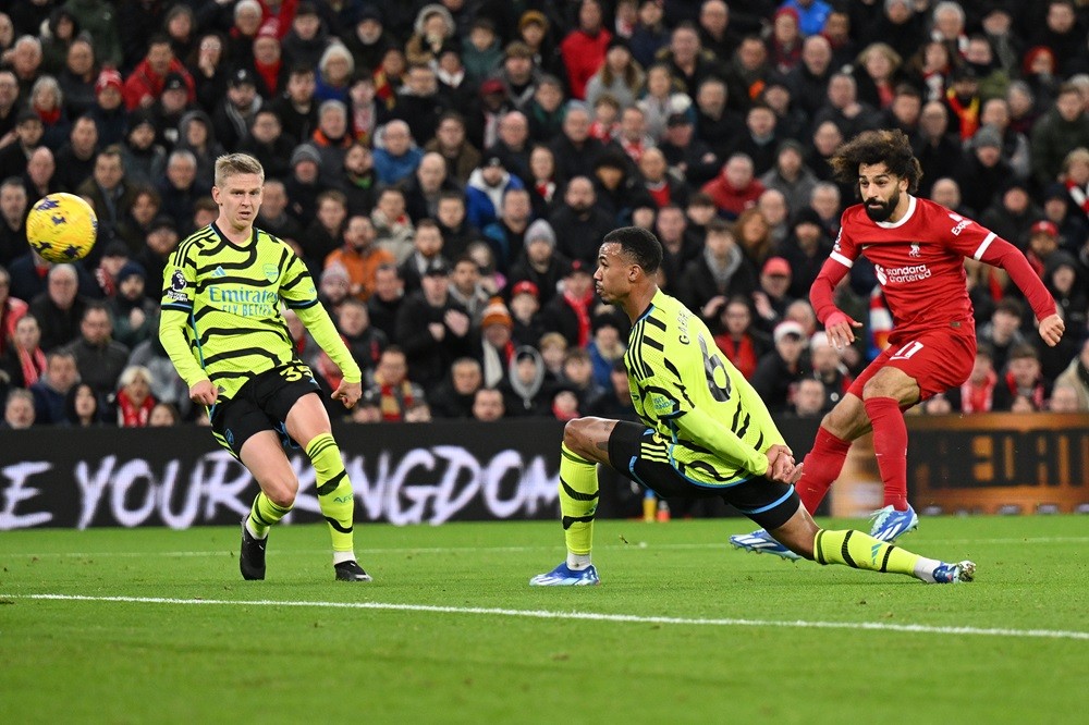 LIVERPOOL, ENGLAND: Mohamed Salah of Liverpool scores their team's first goal during the Premier League match between Liverpool FC and Arsenal FC at Anfield on December 23, 2023. (Photo by Michael Regan/Getty Images)