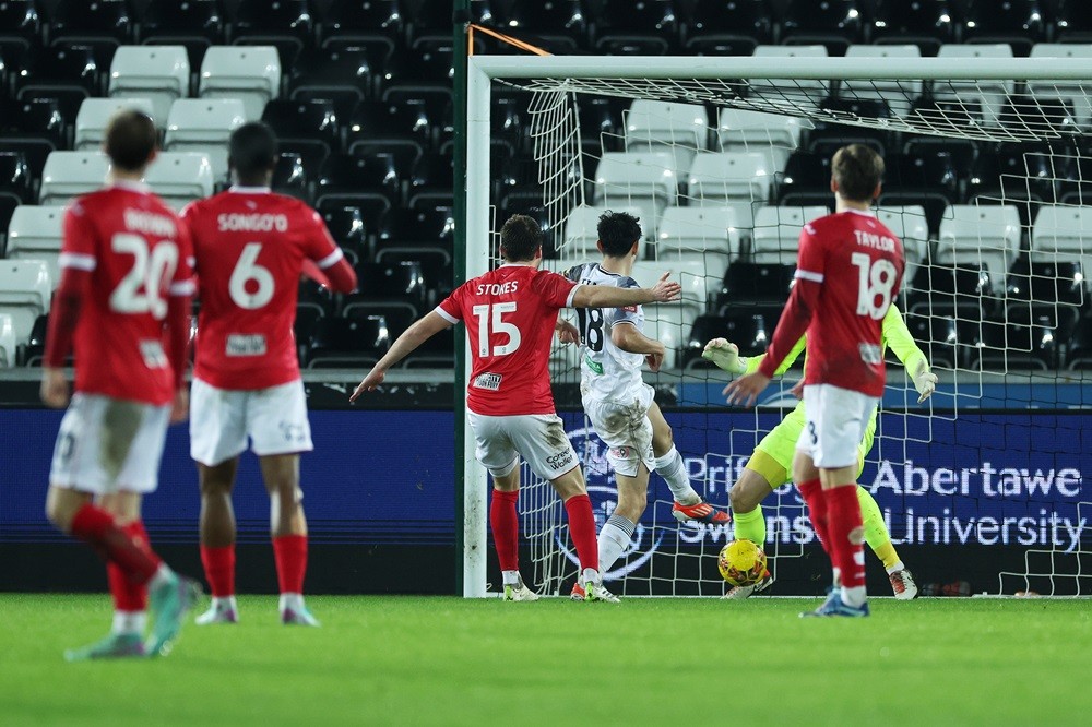 SWANSEA, WALES: Charlie Patino of Swansea City scores his team's first goal during the Emirates FA Cup Third Round match between Swansea City and Morecambe at Swansea.com Stadium on January 06, 2024. (Photo by Eddie Keogh/Getty Images)