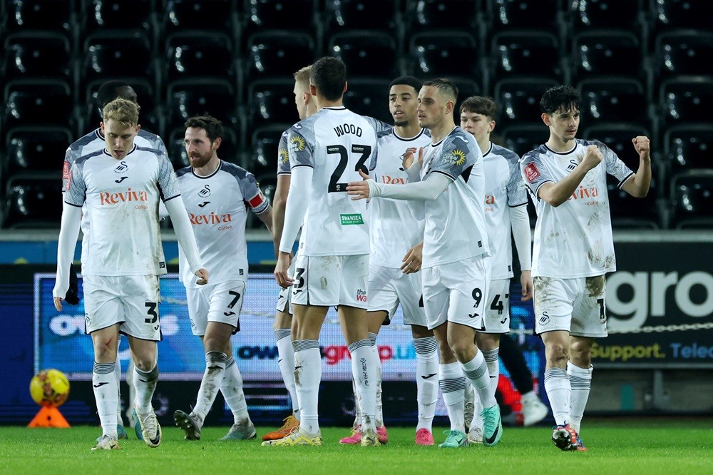 SWANSEA, WALES: Charlie Patino of Swansea City celebrates with teammates after scoring his team's first goal during the Emirates FA Cup Third Round match between Swansea City and Morecambe at Swansea.com Stadium on January 06, 2024. (Photo by Eddie Keogh/Getty Images)