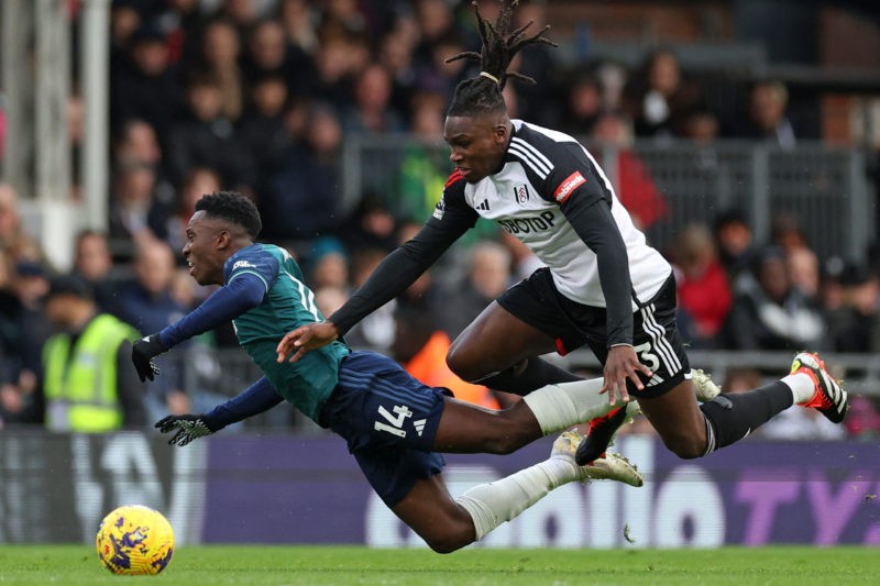 TOPSHOT - Arsenal's English striker #14 Eddie Nketiah (L) vies with Fulham's Italian-born Nigerian defender #03 Calvin Bassey (R) during the English Premier League football match between Fulham and Arsenal at Craven Cottage in London on December 31, 2023. (Photo by ADRIAN DENNIS/AFP via Getty Images)