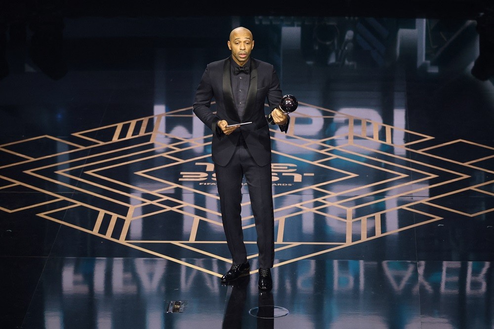 Thierry Henry reacts on stage after collecting The Best FIFA Men's Player award on behalf of Argentina and Inter Miami forward Lionel Messi during the Best FIFA Football Awards 2023 ceremony in London on January 15, 2024. (Photo by ADRIAN DENNIS/AFP via Getty Images)