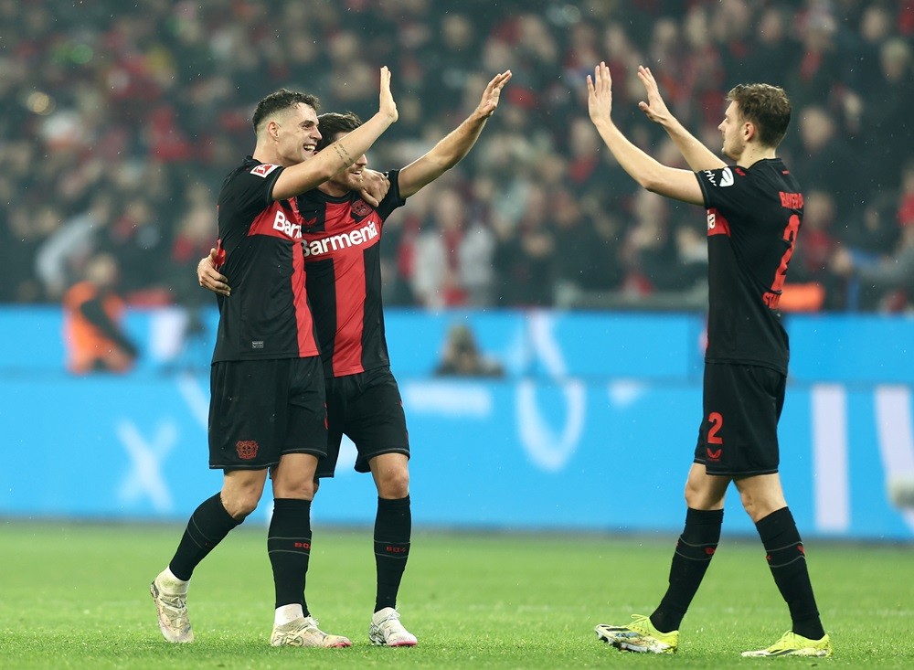 LEVERKUSEN, GERMANY: Granit Xhaka, Jonas Hofmann and Josip Stanisic of Bayer Leverkusen celebrate following the team's victory during the Bundesliga match between Bayer 04 Leverkusen and FC Bayern München at BayArena on February 10, 2024. (Photo by Leon Kuegeler/Getty Images)