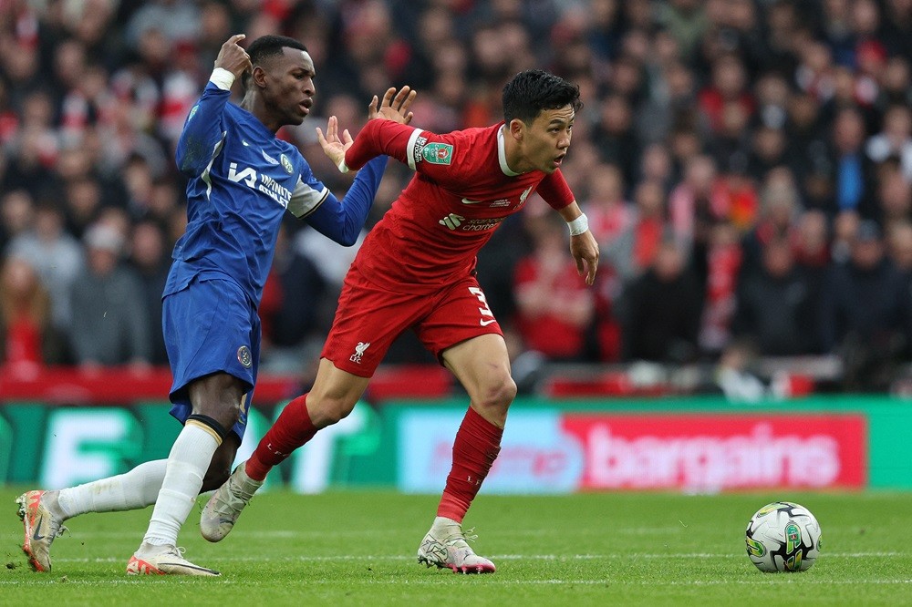 Chelsea's Nicolas Jackson (L) vies with Liverpool's Wataru Endo during the English League Cup final football match between Chelsea and Liverpool at Wembley stadium, in London, on February 25, 2024. (Photo by ADRIAN DENNIS/AFP via Getty Images)