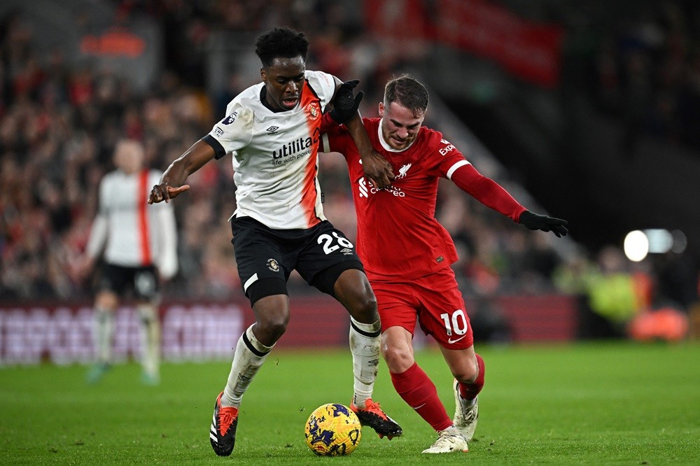 Albert Sambi Lokonga (L) of Luton Town battles for the ball with Alexis Mac Allister of Liverpool during the English Premier League football match between Liverpool and Luton Town at Anfield in Liverpool, north west England on February 21, 2024. (Photo by PAUL ELLIS/AFP via Getty Images)