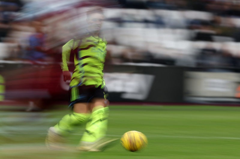 Arsenal's Norwegian midfielder #08 Martin Odegaard passes the ball during the English Premier League football match between West Ham United and Arsenal at the London Stadium, in London on February 11, 2024. (Photo by ADRIAN DENNIS/AFP via Getty Images)