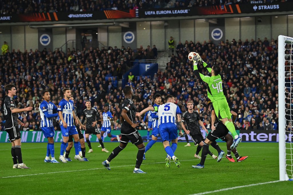Ajax's German goalkeeper #40 Diant Ramaj jumps to make a save during the UEFA Europa League Group B football match between Brighton and Hove Albion and Ajax at the American Express Community Stadium in Brighton, southern England on October 26, 2023. Photo by GLYN KIRK/AFP via Getty Images)