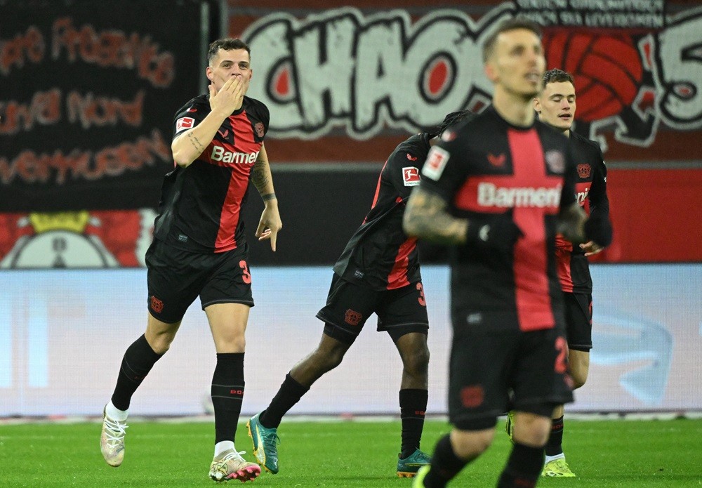 Bayer Leverkusen's Granit Xhaka (L) celebrates scoring the opening goal with his teammates during the German first division Bundesliga football match between Bayer 04 Leverkusen and Mainz 05 in Leverkusen, western Germany on February 23, 2024. (Photo by INA FASSBENDER/AFP via Getty Images)
