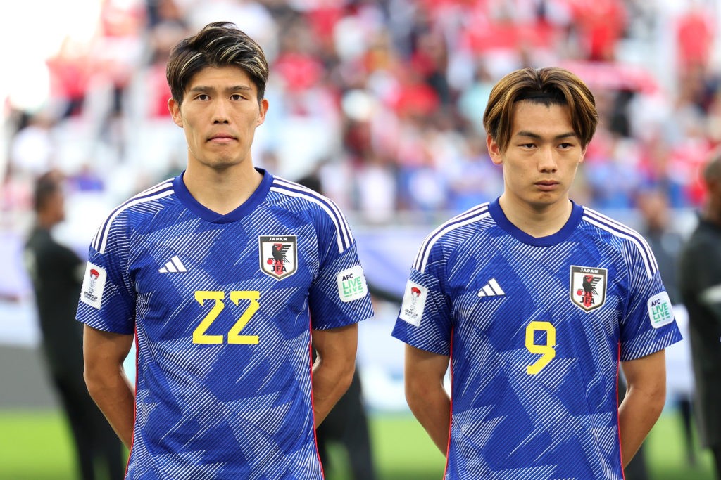 DOHA, QATAR - JANUARY 24: Takehiro Tomiyasu and Ayase Ueda of Japan line up prior to the AFC Asian Cup Group D match between Japan and Indonesia at Al Thumama Stadium on January 24, 2024 in Doha, Qatar. (Photo by Lintao Zhang/Getty Images)