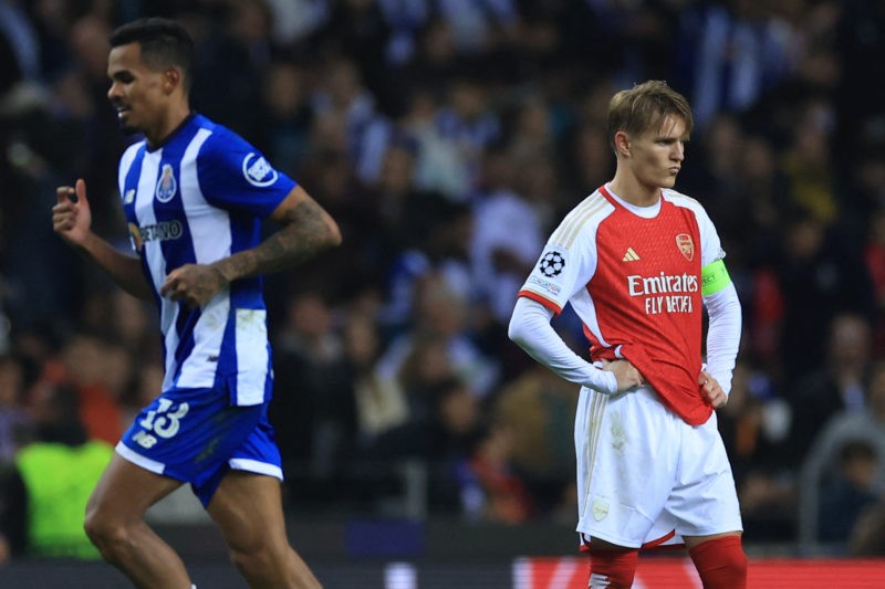 TOPSHOT - Arsenal's Norwegian midfielder #08 Martin Odegaard (R) reacts next to FC Porto's Brazilian midfielder #13 Wenderson Galeno during the UEFA Champions League last 16 first leg football match between FC Porto and Arsenal FC at the Dragao stadium in Porto on February 21, 2024.  (Photo by PATRICIA DE MELO MOREIRA/AFP via Getty Images)