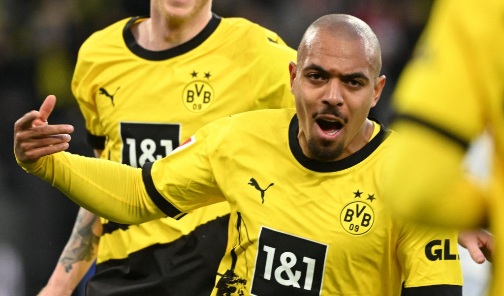 Dortmund's Dutch forward #21 Donyell Malen celebrates scoring the 1-1 goal during the German first division Bundesliga football match between BVB Borussia Dortmund and TSG 1899 Hoffenheim in Dortmund, western Germany, on February 25, 2024. (Photo by INA FASSBENDER / AFP)