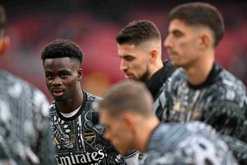 Arsenal's English midfielder #07 Bukayo Saka (L) and teammates warm up ahead of the English Premier League football match between Arsenal and Brentford at the Emirates Stadium in London on March 9, 2024. (Photo by JUSTIN TALLIS/AFP via Getty Images)