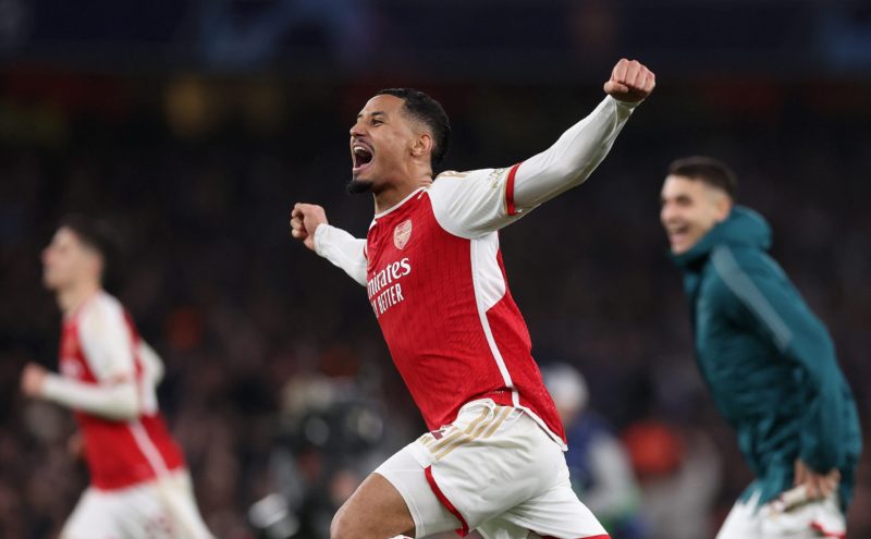 LONDON, ENGLAND - MARCH 12: William Saliba of Arsenal celebrates as David Raya of Arsenal (not pictured) makes the match-winning save from the fourth penalty from Galeno of FC Porto (not pictured) in the penalty shoot out during the UEFA Champions League 2023/24 round of 16 second leg match between Arsenal FC and FC Porto at Emirates Stadium on March 12, 2024 in London, England. (Photo by Julian Finney/Getty Images)