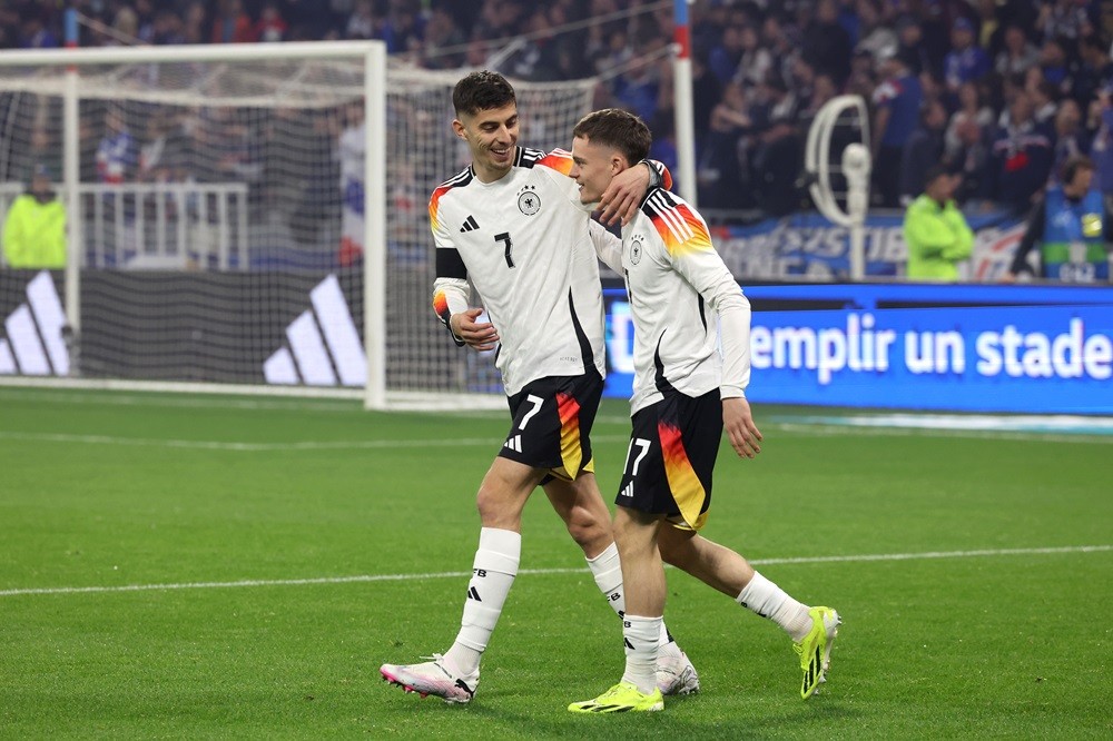 LYON, FRANCE: Florian Wirtz celebrates with Kai Havertz of Germany after scoring his team's first goal during the international friendly match between France and Germany at Groupama Stadium on March 23, 2024. (Photo by Alexander Hassenstein/Getty Images)