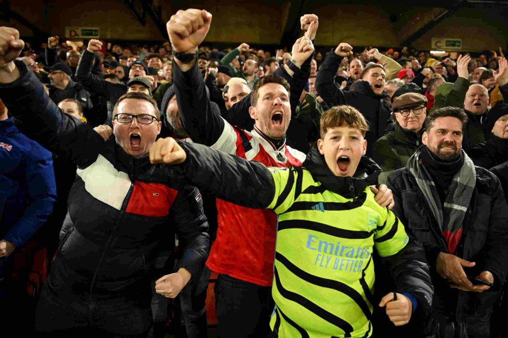 SHEFFIELD, ENGLAND - MARCH 04: Arsenal fans celebrate after their sides second goal, an own goal by Jayden Bogle of Sheffield United (not pictured), during the Premier League match between Sheffield United and Arsenal FC at Bramall Lane on March 04, 2024 in Sheffield, England. (Photo by Michael Regan/Getty Images)