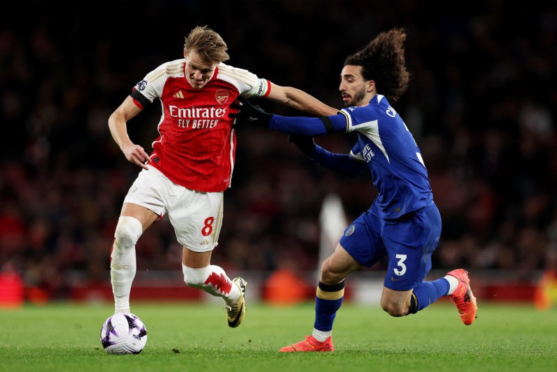 LONDON, ENGLAND - APRIL 23: Martin Odegaard of Arsenal is challenged by Marc Cucurella of Chelsea during the Premier League match between Arsenal FC and Chelsea FC at Emirates Stadium on April 23, 2024 in London, England. (Photo by Julian Finney/Getty Images)