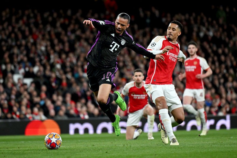 LONDON, ENGLAND - APRIL 09: Leroy Sane of Bayern Munich is tackled by William Saliba of Arsenal leading to a penalty decision for Bayern Munich during the UEFA Champions League quarter-final first leg match between Arsenal FC and FC Bayern München at Emirates Stadium on April 09, 2024 in London, England. (Photo by Shaun Botterill/Getty Images)