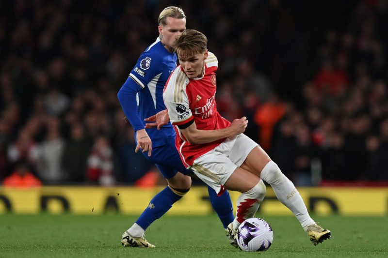Arsenal's Norwegian midfielder #08 Martin Odegaard (R) turns away from Chelsea's Ukrainian midfielder #10 Mykhailo Mudryk (L) during the English Premier League football match between Arsenal and Chelsea at the Emirates Stadium in London on April 23, 2024. (Photo by GLYN KIRK/AFP via Getty Images)