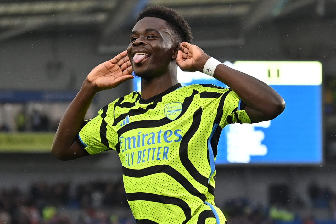 Arsenal's English midfielder #07 Bukayo Saka celebrates after scoring the opening goal from the penalty spot during the English Premier League football match between Brighton and Hove Albion and Arsenal at the American Express Community Stadium in Brighton, southern England on April 6, 2024. (Photo by GLYN KIRK/AFP via Getty Images)