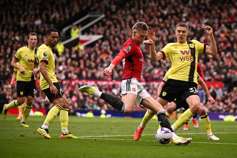Manchester United's Scott McTominay (C) shoots the ball during the English Premier League football match between Manchester United and Burnley at Old Trafford in Manchester, north west England, on April 27, 2024. (Photo by OLI SCARFF/AFP via Getty Images)