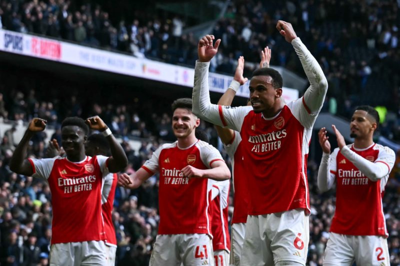 Arsenal's Brazilian defender #06 Gabriel Magalhaes (C) celebrates with teammates at the end of during the English Premier League football match between Tottenham Hotspur and Arsenal at the Tottenham Hotspur Stadium in London, on April 28, 2024. Arsenal wins 3 - 2 against Tottenham Hotspur. (Photo by BEN STANSALL/AFP via Getty Images)