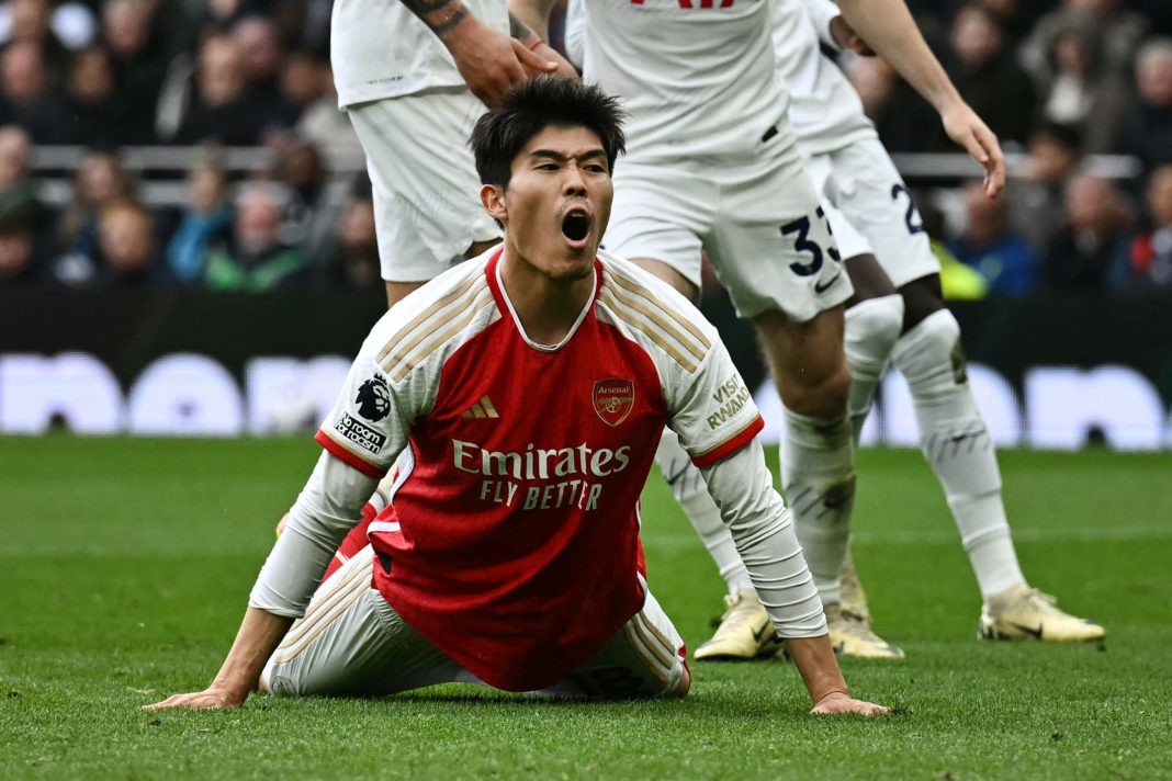 Arsenal's Japanese defender #18 Takehiro Tomiyasu reacts after missing to score during the English Premier League football match between Tottenham Hotspur and Arsenal at the Tottenham Hotspur Stadium in London, on April 28, 2024. (Photo by BEN STANSALL/AFP via Getty Images)