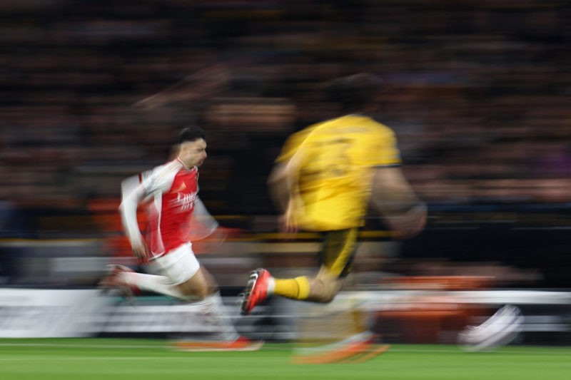 Arsenal's Brazilian midfielder #11 Gabriel Martinelli (L) runs with the ball during the English Premier League football match between Wolverhampton Wanderers and Arsenal at the Molineux stadium in Wolverhampton, central England on April 20, 2024. (Photo by HENRY NICHOLLS/AFP via Getty Images)