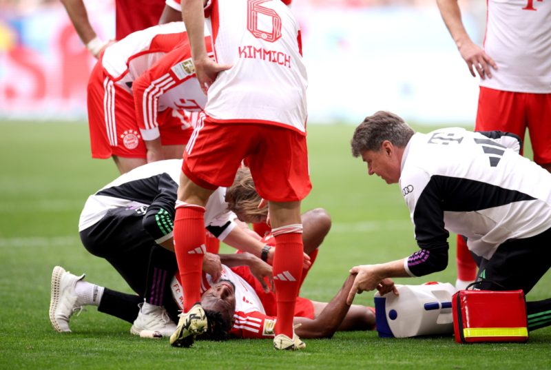 MUNICH, GERMANY - APRIL 13: Kingsley Coman of Bayern Munich receives medical treatment during the Bundesliga match between FC Bayern München and 1. FC Köln at Allianz Arena on April 13, 2024 in Munich, Germany. (Photo by Adam Pretty/Getty Images)
