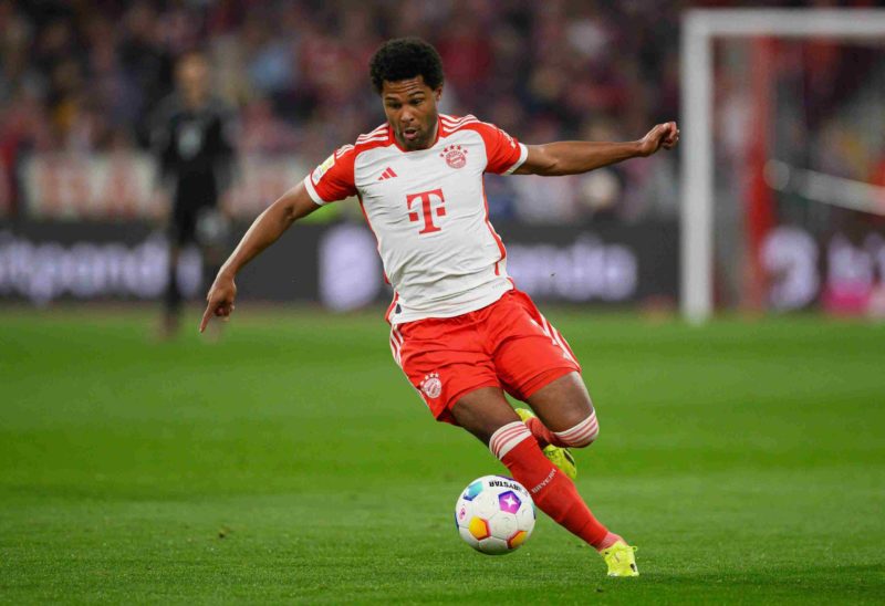 MUNICH, GERMANY - MARCH 30: Serge Gnabry of Bayern Munich controls the ball during the Bundesliga match between FC Bayern München and Borussia Dortmund at Allianz Arena on March 30, 2024 in Munich, Germany. (Photo by Matthias Hangst/Getty Images)