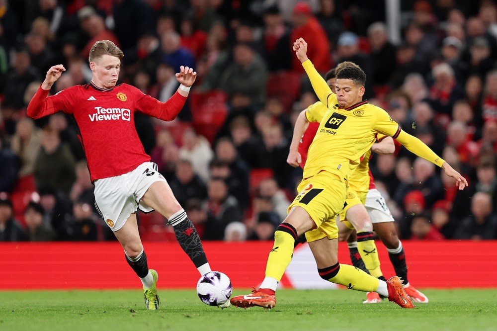 MANCHESTER, ENGLAND: William Osula of Sheffield United battles for possession with Scott McTominay of Manchester United during the Premier League match between Manchester United and Sheffield United at Old Trafford on April 24, 2024. (Photo by Matt McNulty/Getty Images)