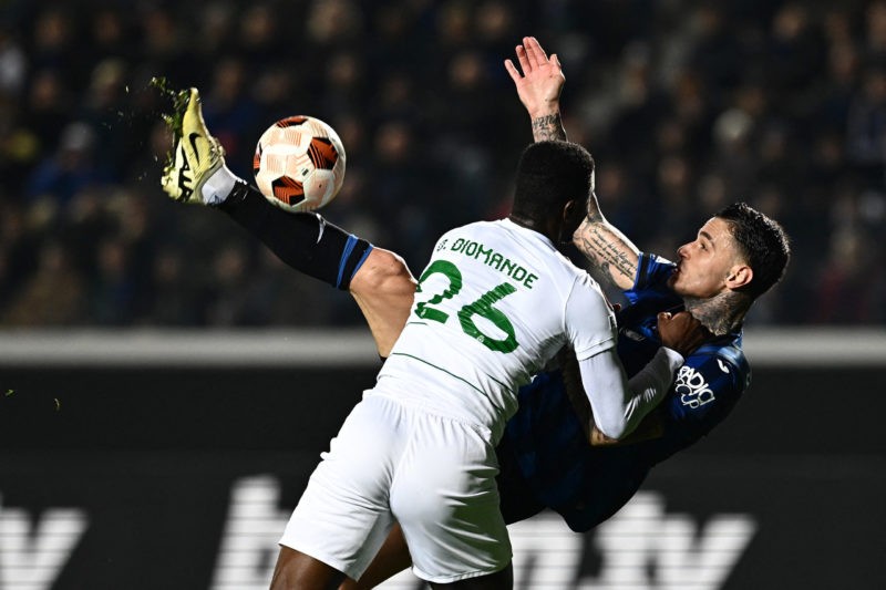 TOPSHOT - Atalanta's Italian forward #90 Gianluca Scamacca (R) fights for the ball with Sporting Lisbon's Ivorian defender #26 Ousmane Diomande during the UEFA Europa League last 16 second leg football match between Atalanta and Sporting CP at the Atleti Azzurri d'Italia Stadium in Bergamo on March 14, 2024. (Photo by GABRIEL BOUYS/AFP via Getty Images)