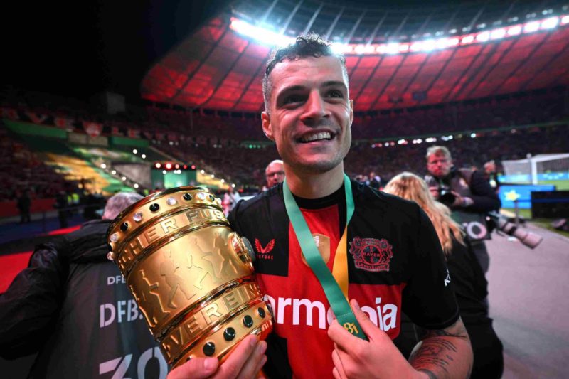 BERLIN, GERMANY - MAY 25: Granit Xhaka of Bayer 04 Leverkusen celebrates with the DFB-Pokal Trophy after his team's victory in the DFB Cup 2023/24 final match between 1. FC Kaiserslautern and Bayer 04 Leverkusen at Olympiastadion on May 25, 2024 in Berlin, Germany. (Photo by Stuart Franklin/Getty Images)