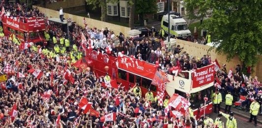 LONDON - MAY 12: Arsenal parade their trophies during Arsenal's open top bus parade of the AXA FA Cup and the FA Barclaycard Premiership trophy to their fans held on May 12, 2002 at the Islington Town Hall in London, England. (Photo by: Craig Prentis/Getty Images)