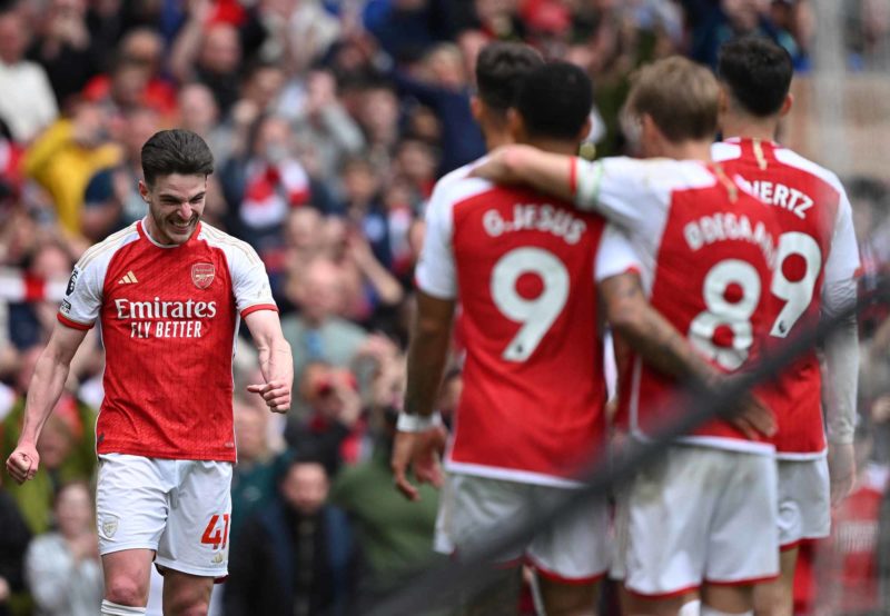 Arsenal's English midfielder #41 Declan Rice (L) celebrates scoring the team's third goal during the English Premier League football match between Arsenal and Bournemouth at the Emirates Stadium, in London, on May 4, 2024. (Photo by JUSTIN TALLIS/AFP via Getty Images)