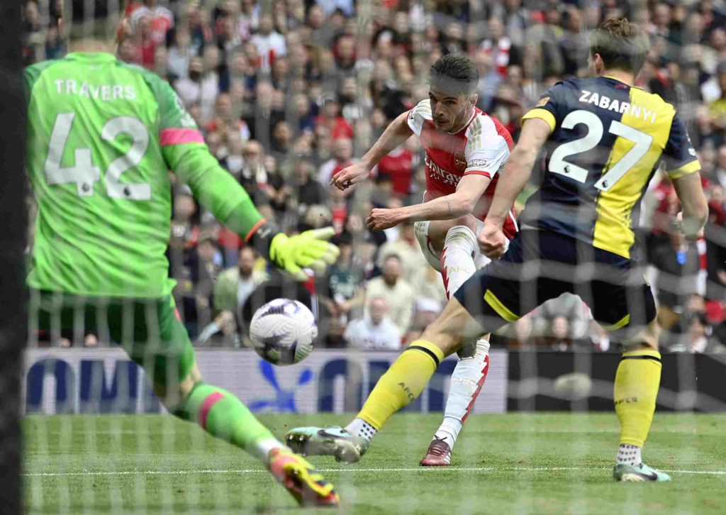 Arsenal's English midfielder #41 Declan Rice scores the team's third goal during the English Premier League football match between Arsenal and Bournemouth at the Emirates Stadium, in London, on May 4, 2024. (Photo by JUSTIN TALLIS/AFP via Getty Images)