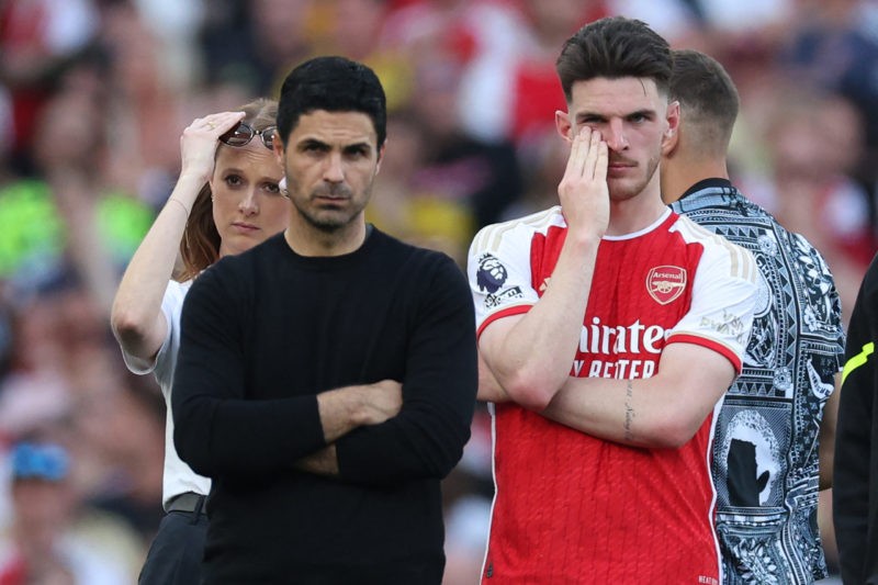 Arsenal's English midfielder #41 Declan Rice (R) and Arsenal's Spanish manager Mikel Arteta (L) react on the pitch after the English Premier League football match between Arsenal and Everton at the Emirates Stadium in London on May 19, 2024. Arsenal won the game 2-1, but lose out to Manchester City in the title race. (Photo by ADRIAN DENNIS/AFP via Getty Images)