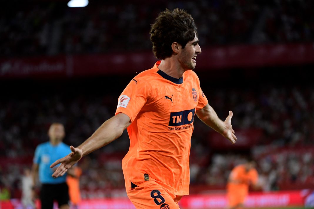 Valencia's Spanish midfielder #8 Javi Guerra celebrates scoring his team's second goal during the Spanish Liga football match between Sevilla FC and Valencia CF at the Ramon Sanchez Pizjuan stadium in Seville on August 11, 2023. (Photo by CRISTINA QUICLER/AFP via Getty Images)